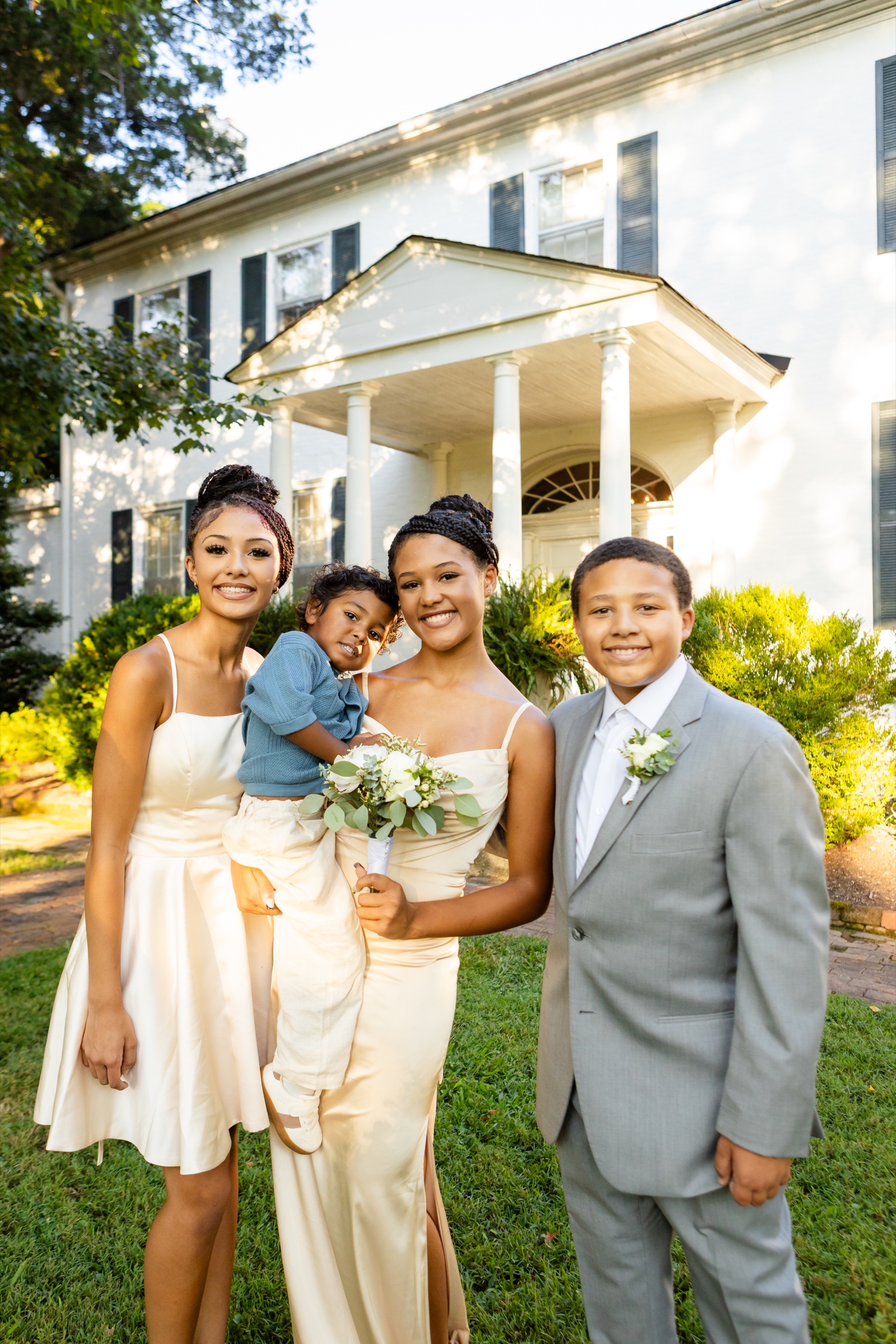 Children posing in front of the mansion